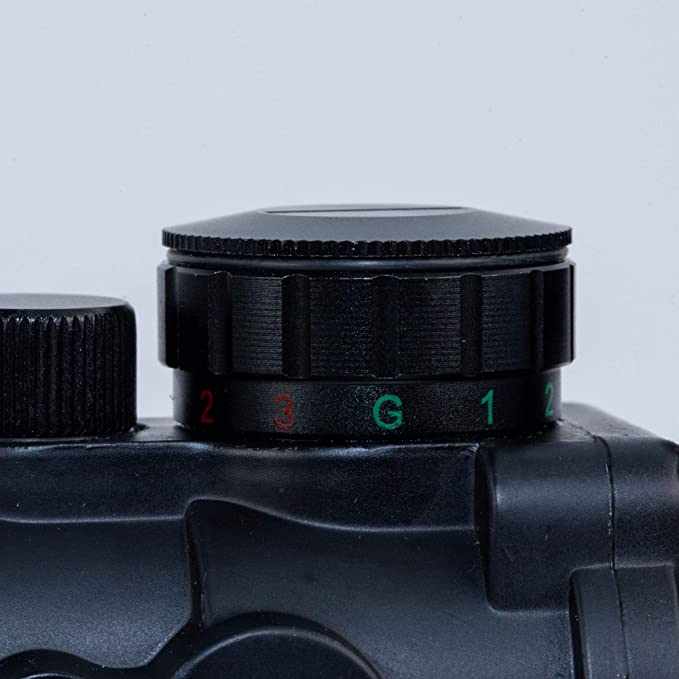 Close-up of black 4x32MDG rifle scope adjustment dial with red and green markings on matte finish body
