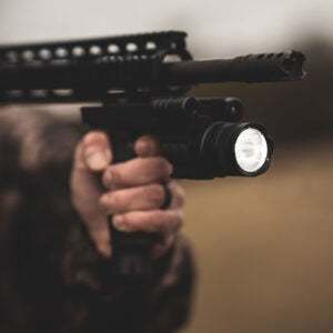 Osprey Battlegrip Blue Laser and Flashlight Combo mounted on rifle with bright LED light.