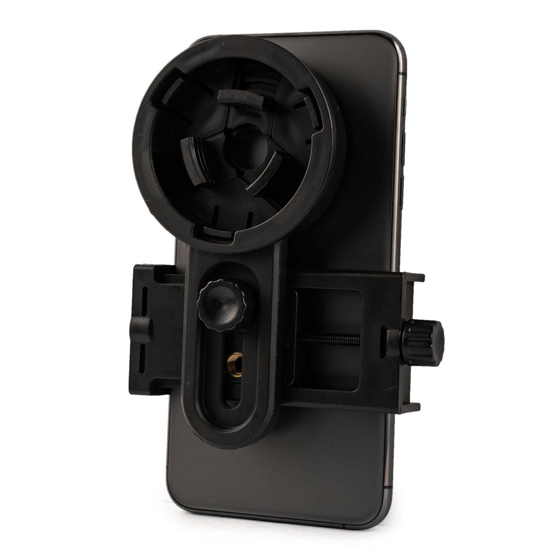 Black camera adapter attached to smartphone for use with spotting scopes, compatible with most smartphones and backed by lifetime warranty
