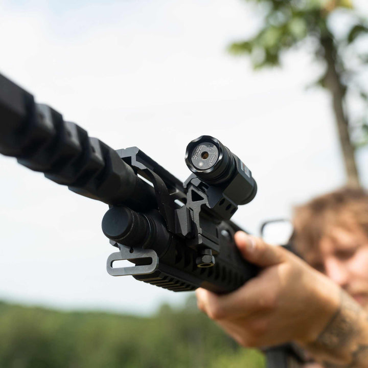 Osprey green rifle laser mounted on Picatinny rail for tactical aiming